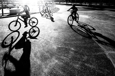 Shadow of man riding bicycle on street