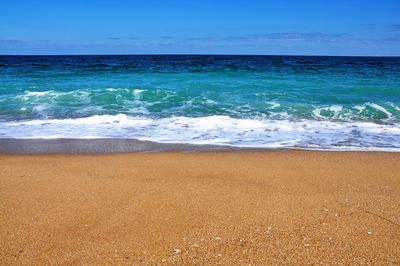 Scenic view of sea against blue sky