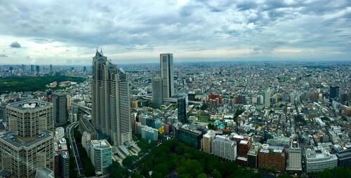 High angle view of modern buildings in city against sky