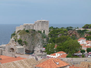 Historic building by sea against sky in old town