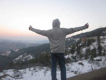 Full length of man standing on snow covered landscape