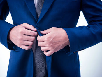 Midsection of man with umbrella