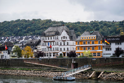 Houses in town by rhine river against sky