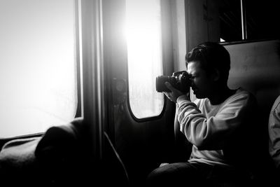 Man sitting on window at home