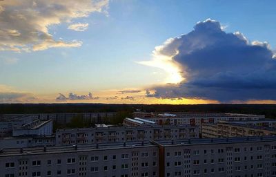 Clouds over city at sunset