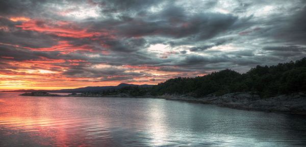 Scenic view of lake against dramatic sky