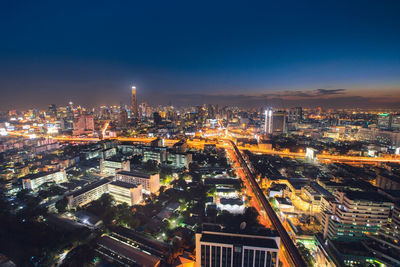 High angle view of illuminated buildings in city at night