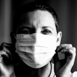 Close-up portrait of man covering face with hand