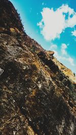 Low angle view of rock formation against sky