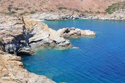 High angle view of rocks on sea shore