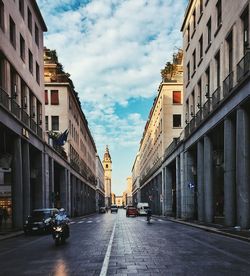 Street amidst buildings in city against sky