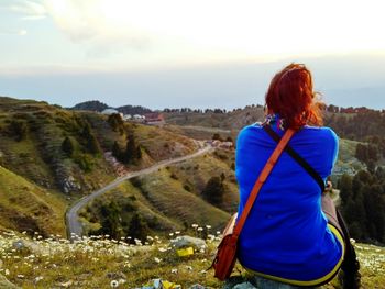 Rear view of woman standing on landscape