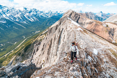 Hiker on grizzly peak summit in kananaskis country canadian rockies