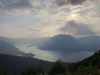 Scenic view of sea and mountains against sky