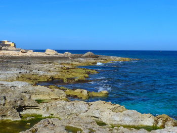 Scenic view of sea against clear blue sky