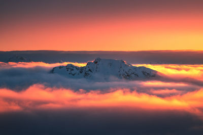 Scenic view of snow covered mountains against romantic sky