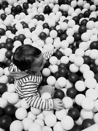 High angle view of boy playing in ball pool