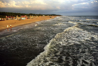 View of people on beach against sky