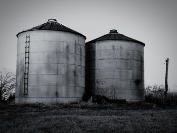 Old building in field against clear sky