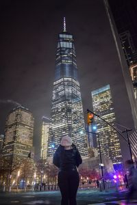 Low angle view of woman standing at night