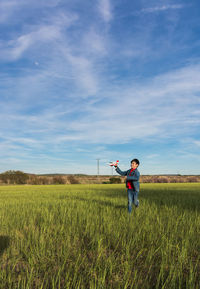 Man standing on field against sky