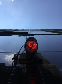 Low angle view of illuminated lamp against sky