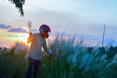 Rear view of man standing on field