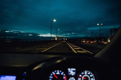 Road seen through car windshield at night