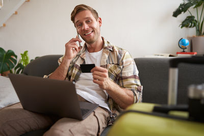 Senior woman using laptop while sitting at home