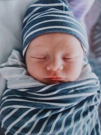 Close-up of baby boy sleeping on bed