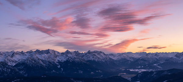 Scenic view of snowcapped mountains against sky during sunset