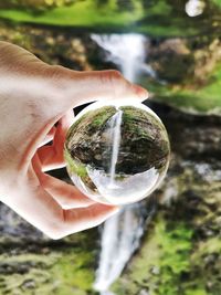 Close-up of hand holding crystal ball