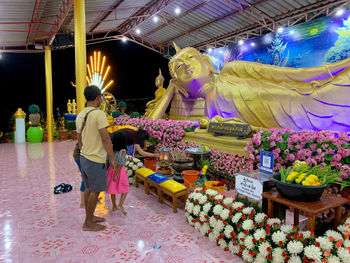 People at illuminated market stall