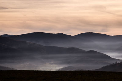 Scenic view of mountains against dramatic sky