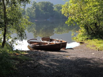 Boat moored at shore against sky