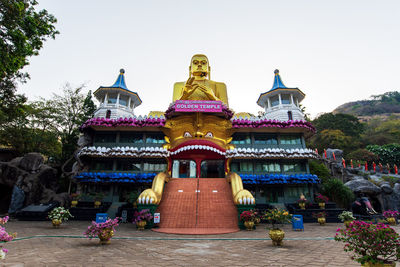 Statue of temple against building