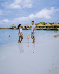 Couple on beach against sky