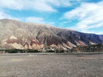 Scenic view of mountain against cloudy sky