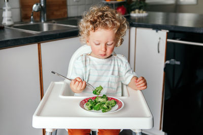 Cute girl having food at home