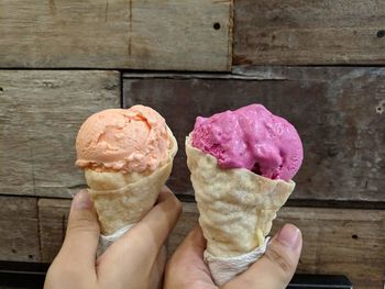 Cropped hand holding ice cream cone