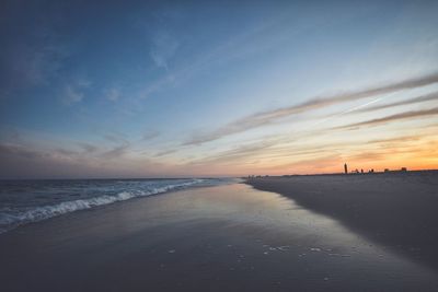 Scenic view of beach against sky during sunset