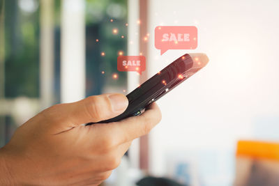 Close-up of hand holding mobile phone