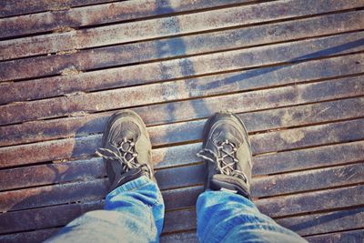 Low section of man standing on tiled floor