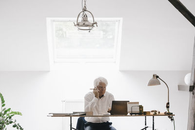 Senior businessman working with laptop in his office