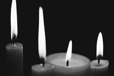 Close-up of lit candle in dark room