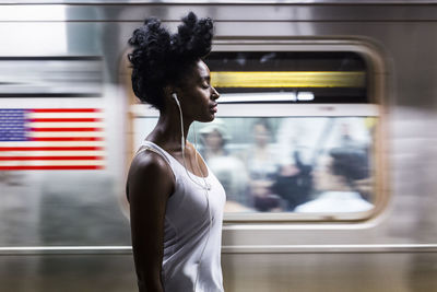 Side view of woman standing by train