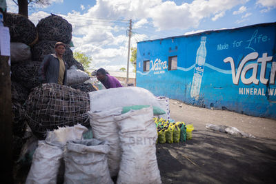 Rear view of people standing on road