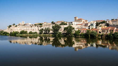 Houses in town against clear sky