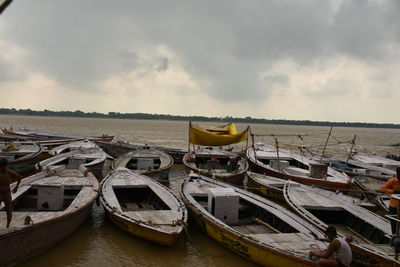 Boats moored on sea against sky