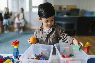 Boy playing in playschool